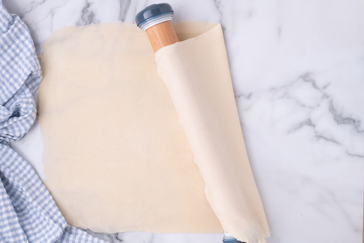 draping pie crust over rolling pin