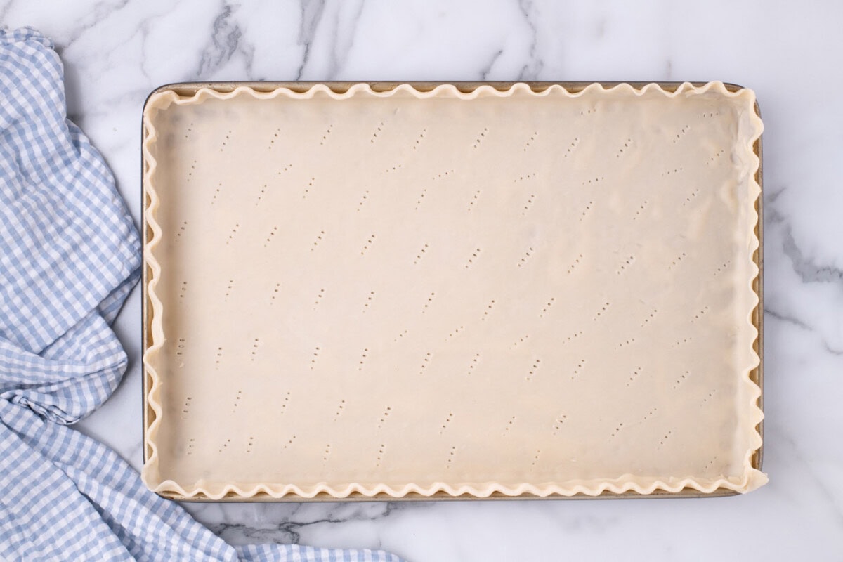 pie crust with fluted edges in a jelly roll pan