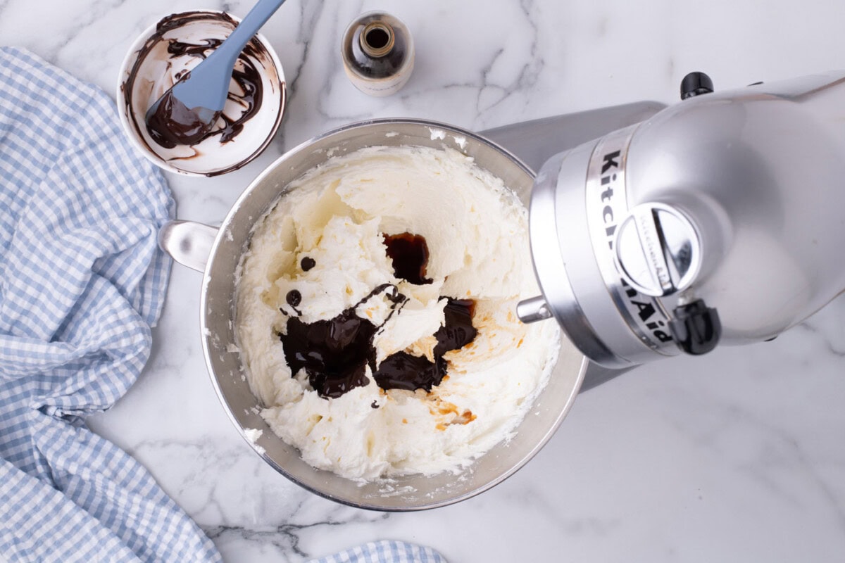 melted chocolate added to butter and sugar in a stand mixer