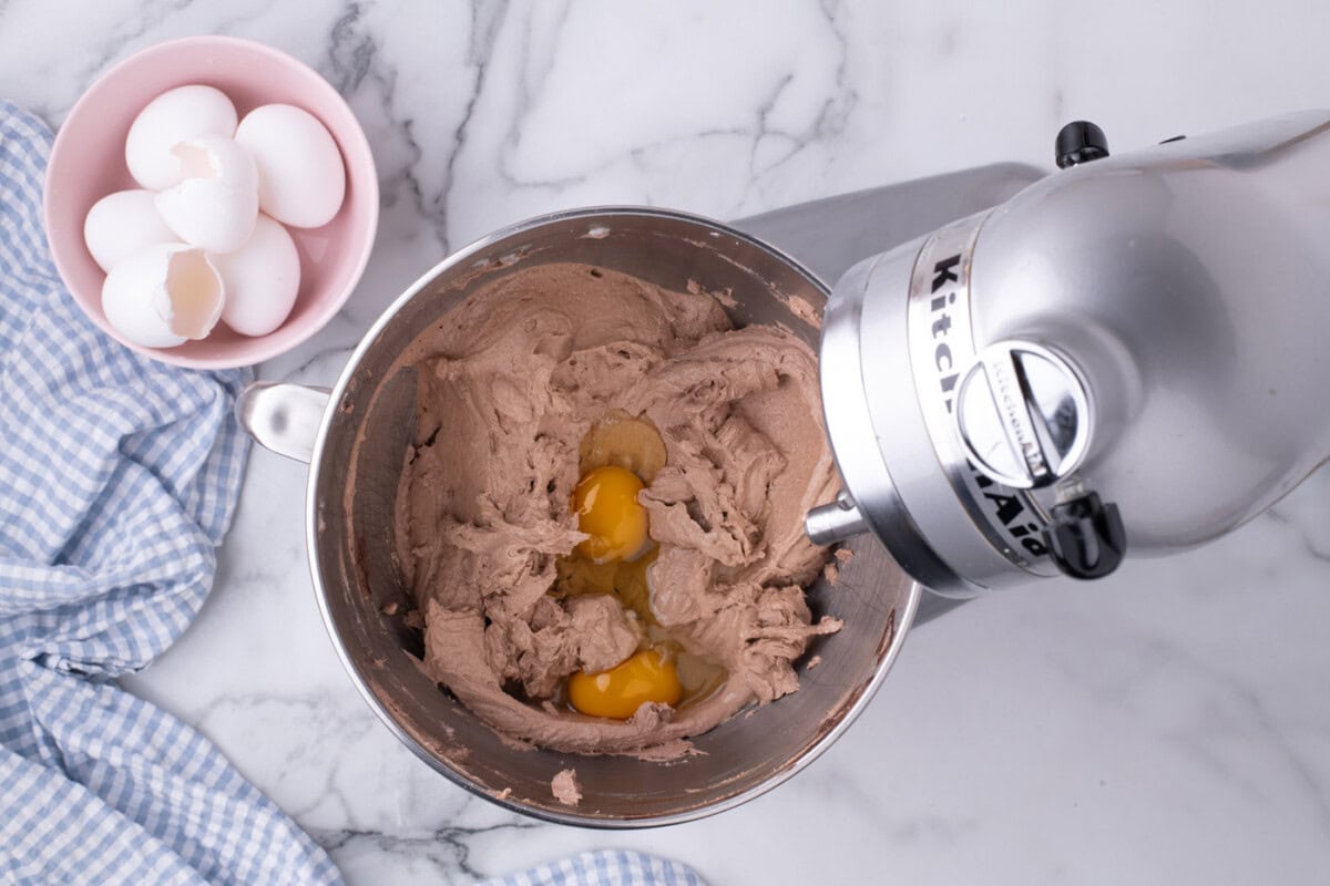 adding eggs to pie filling in a mixer