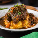 Close up photo of Instant Pot Beef Shanks onto of mashed potatoes