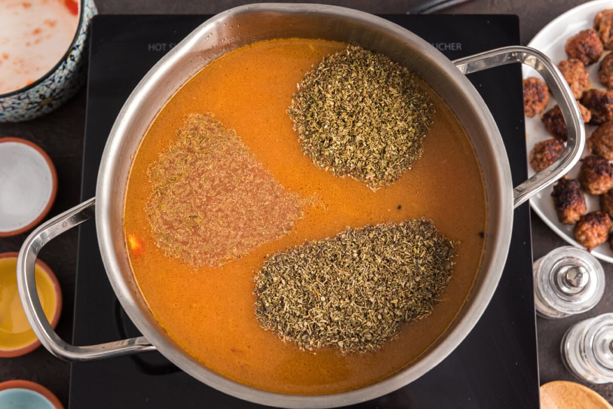 seasonings added to soup in pot