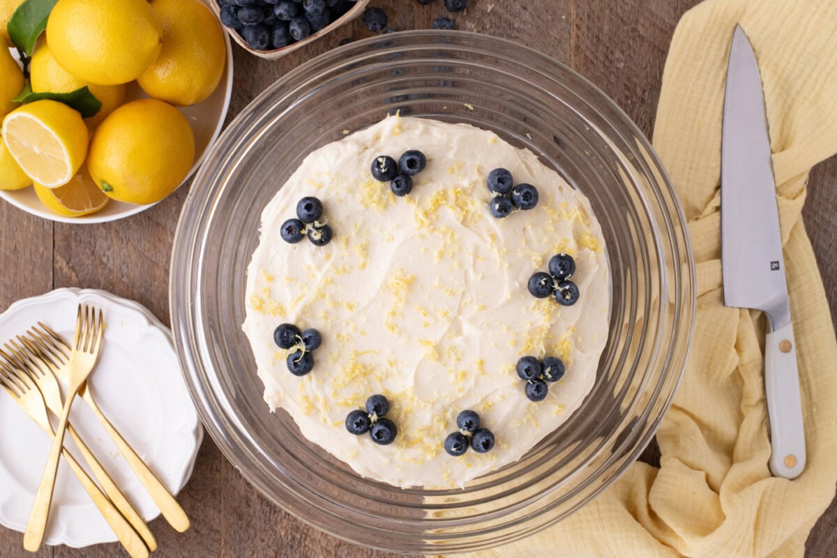 blueberry clusters and lemon zest over lemon blueberry cake