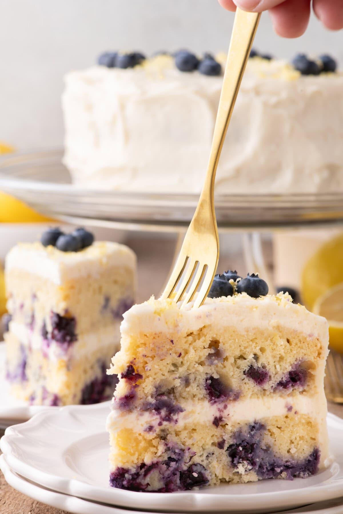 Fork going into a slice of Lemon Blueberry Cake