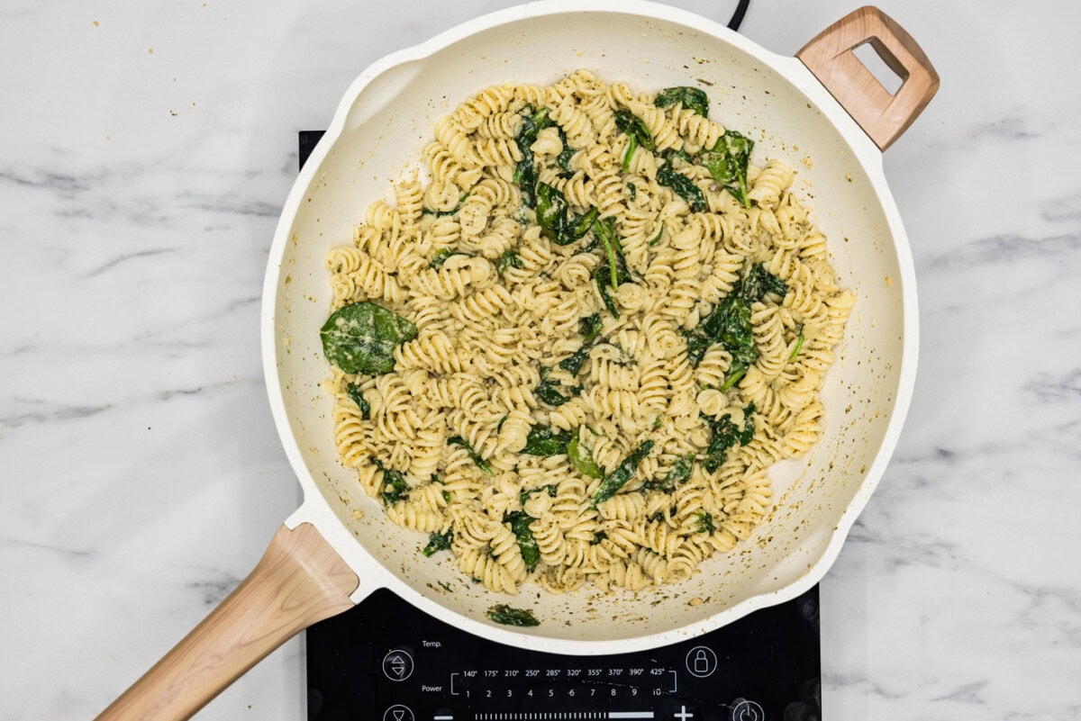 overhead of pesto pasta in a skillet
