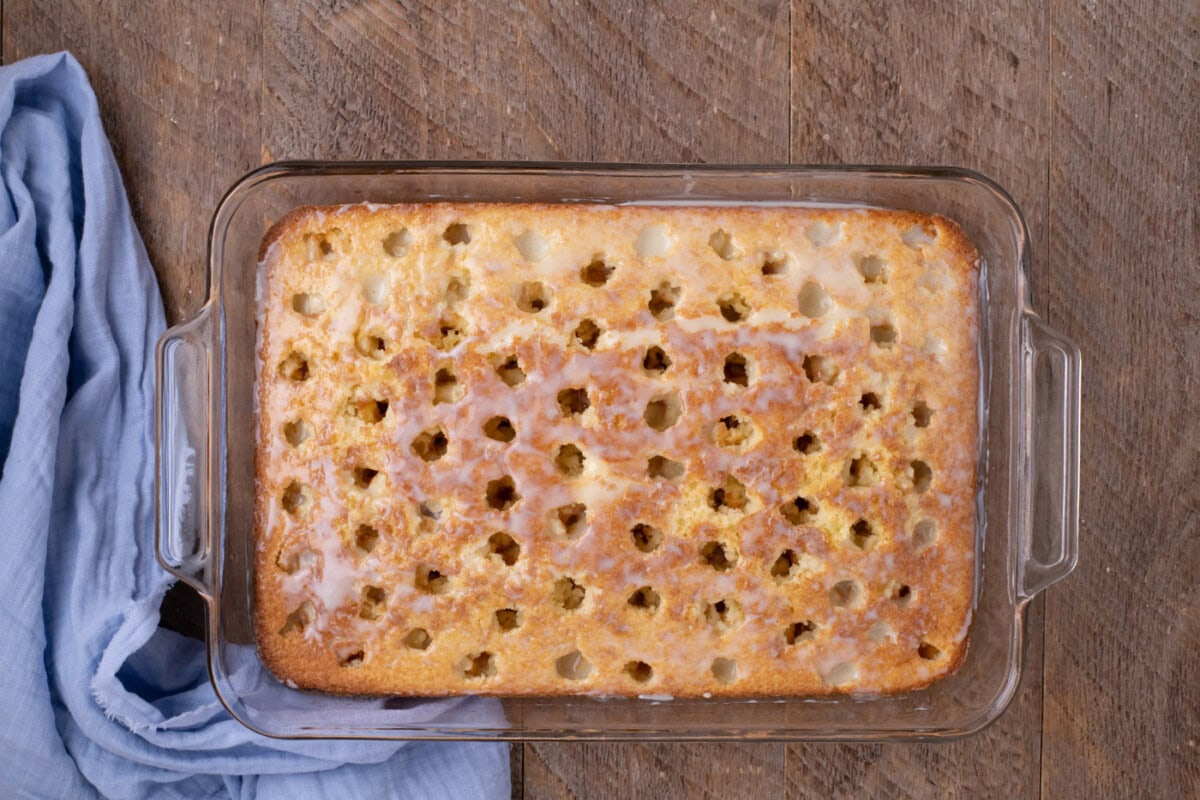 sweetened condensed milk over poke cake