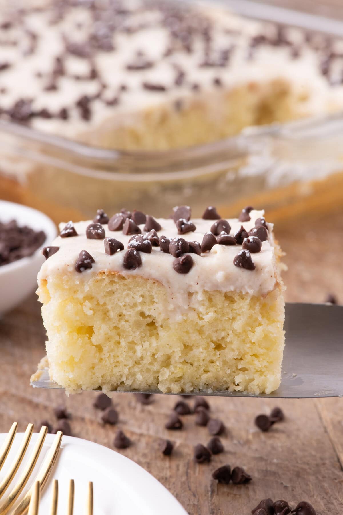 Cannoli Poke Cake slice on a spatula