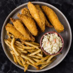 Fried Perch on a plate with fries and coleslaw