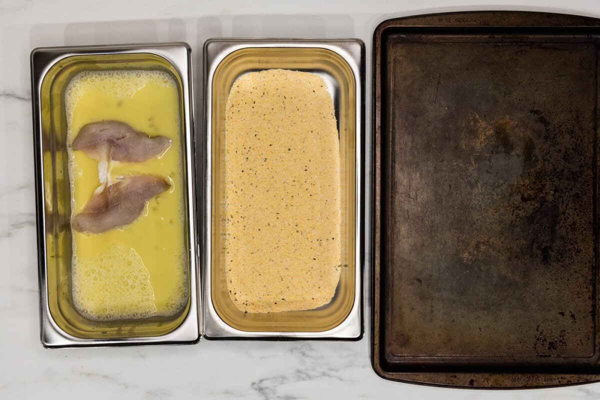 perch filets in egg mixture in a breading tray