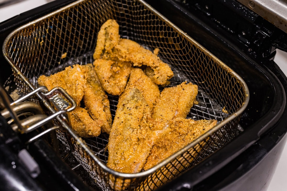fried perch in a deep fryer basket