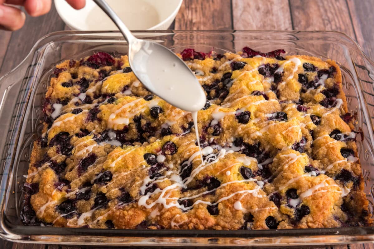 drizzling glaze over lemon blueberry cake