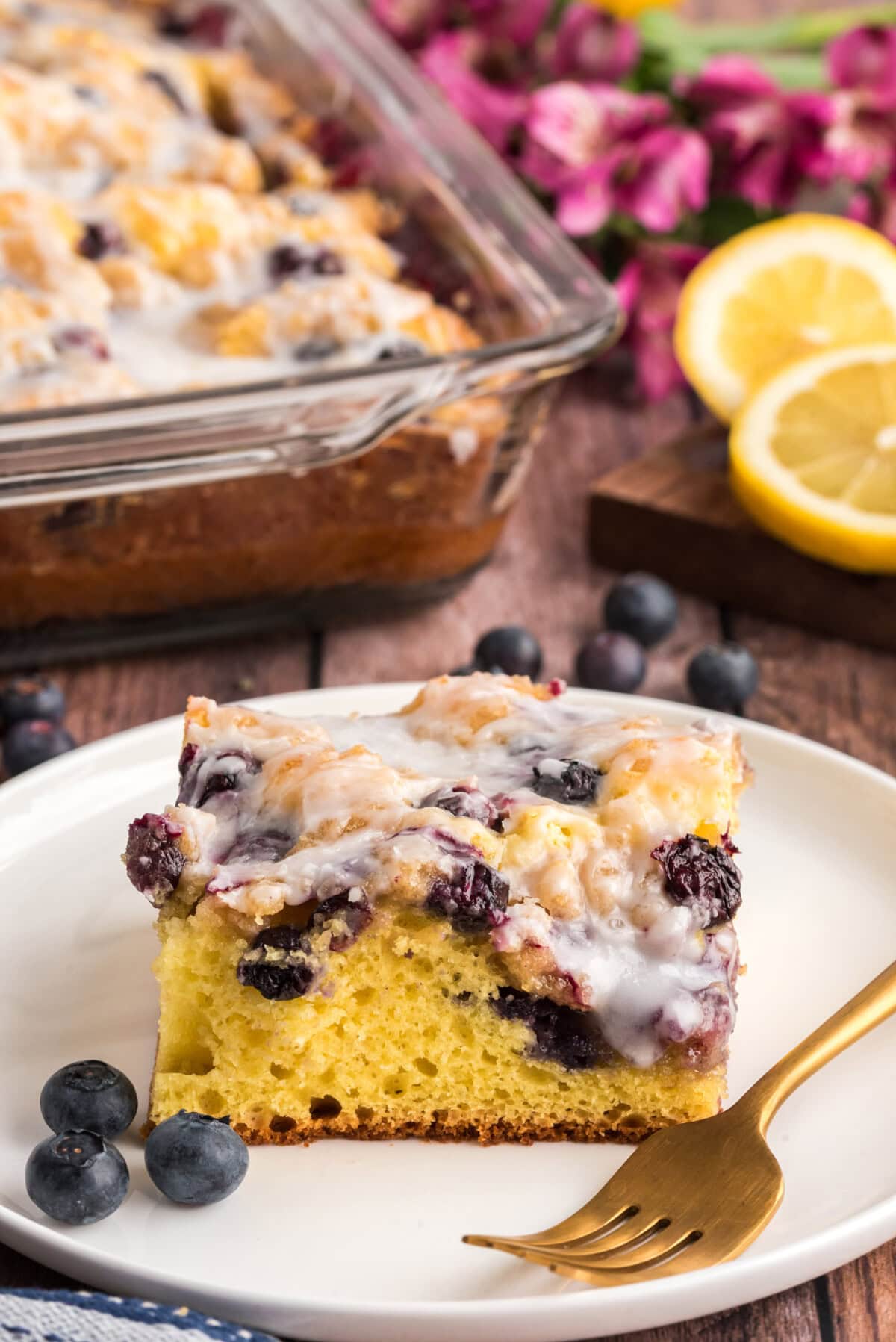 Slice of Glazed Lemon Blueberry Cake on a plate