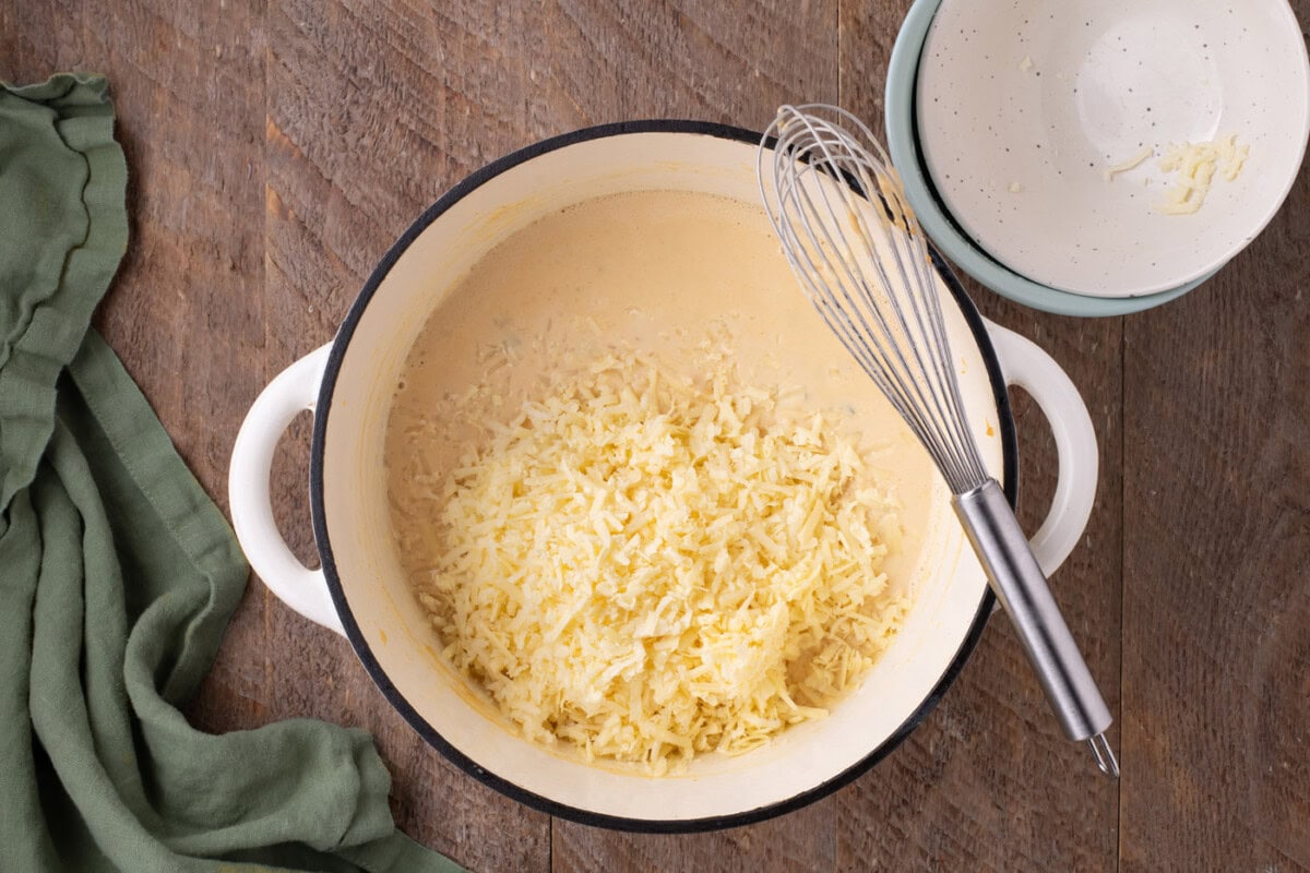 cheese added to jalapeno mixture in a pot