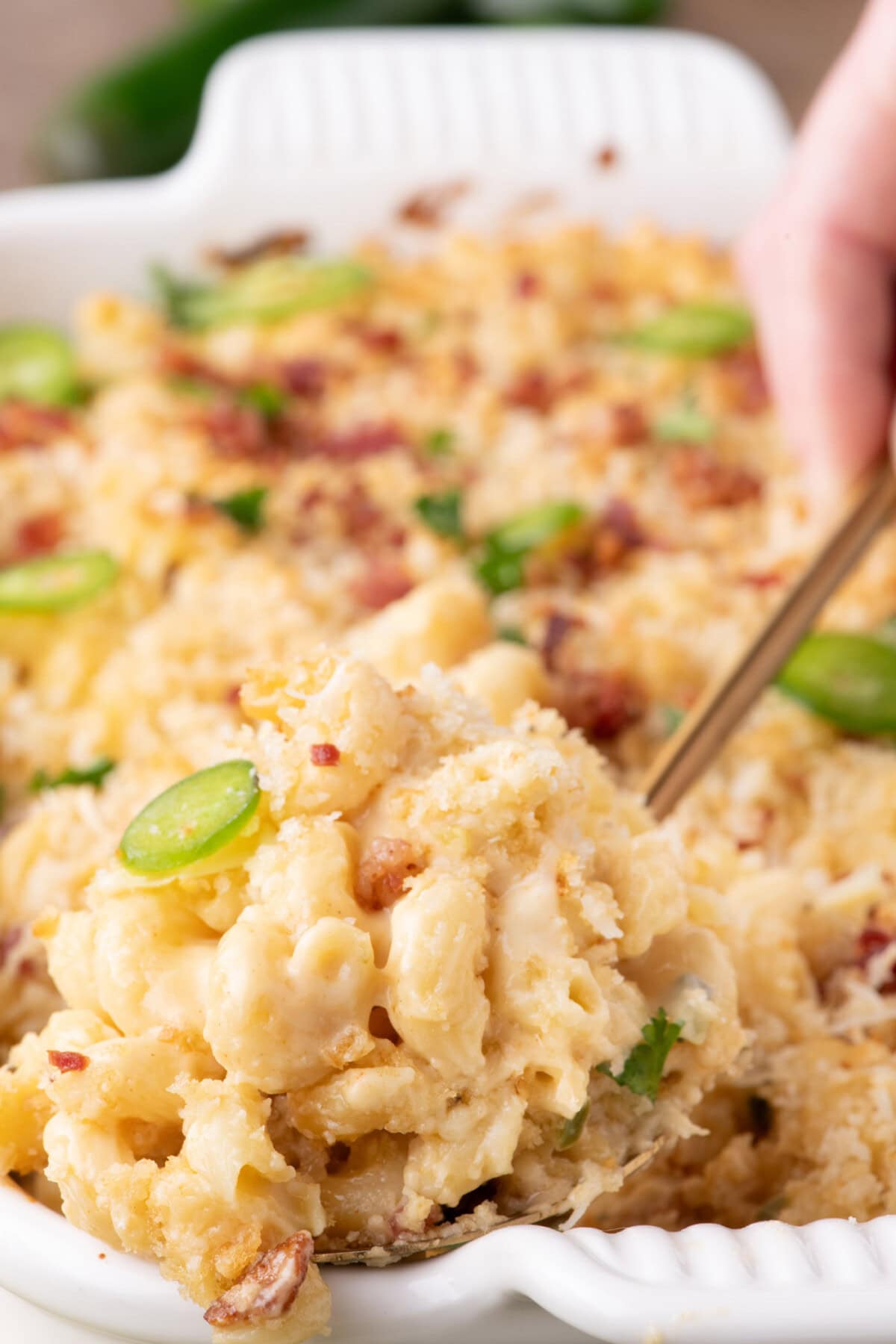 Spoon lifting out a serving of Jalapeno Popper Mac and Cheese