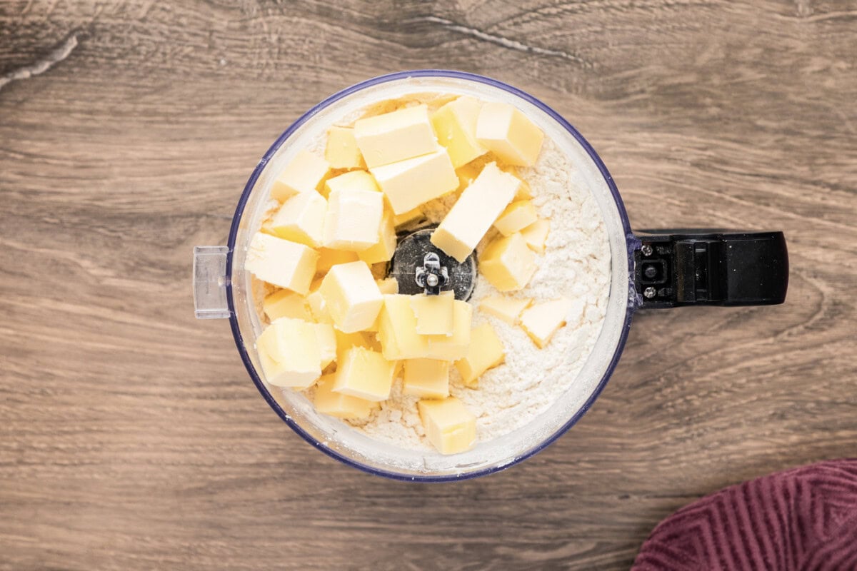 Butter on top of flour mixture in a food processor