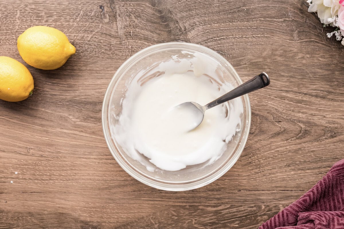 Mixed icing in a bowl with a spoon