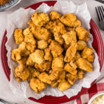 Close up photo of Popcorn Chicken on a parchment paper lined plate
