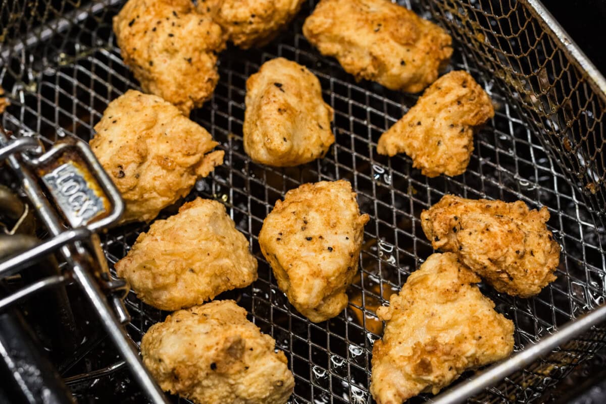 popcorn chicken in a fryer basket