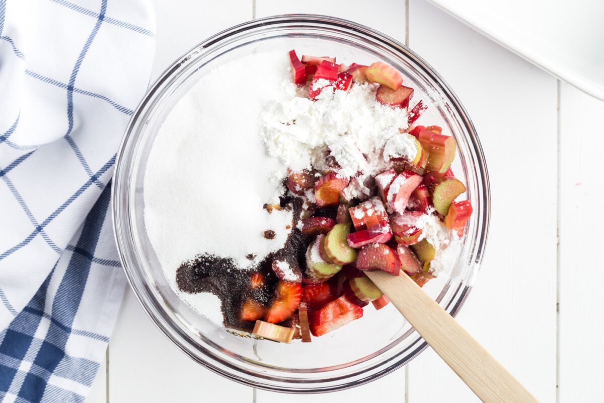 Bowl of rhubarb, strawberries, and blueberries, sugar, cornstarch and balsamic vinegar