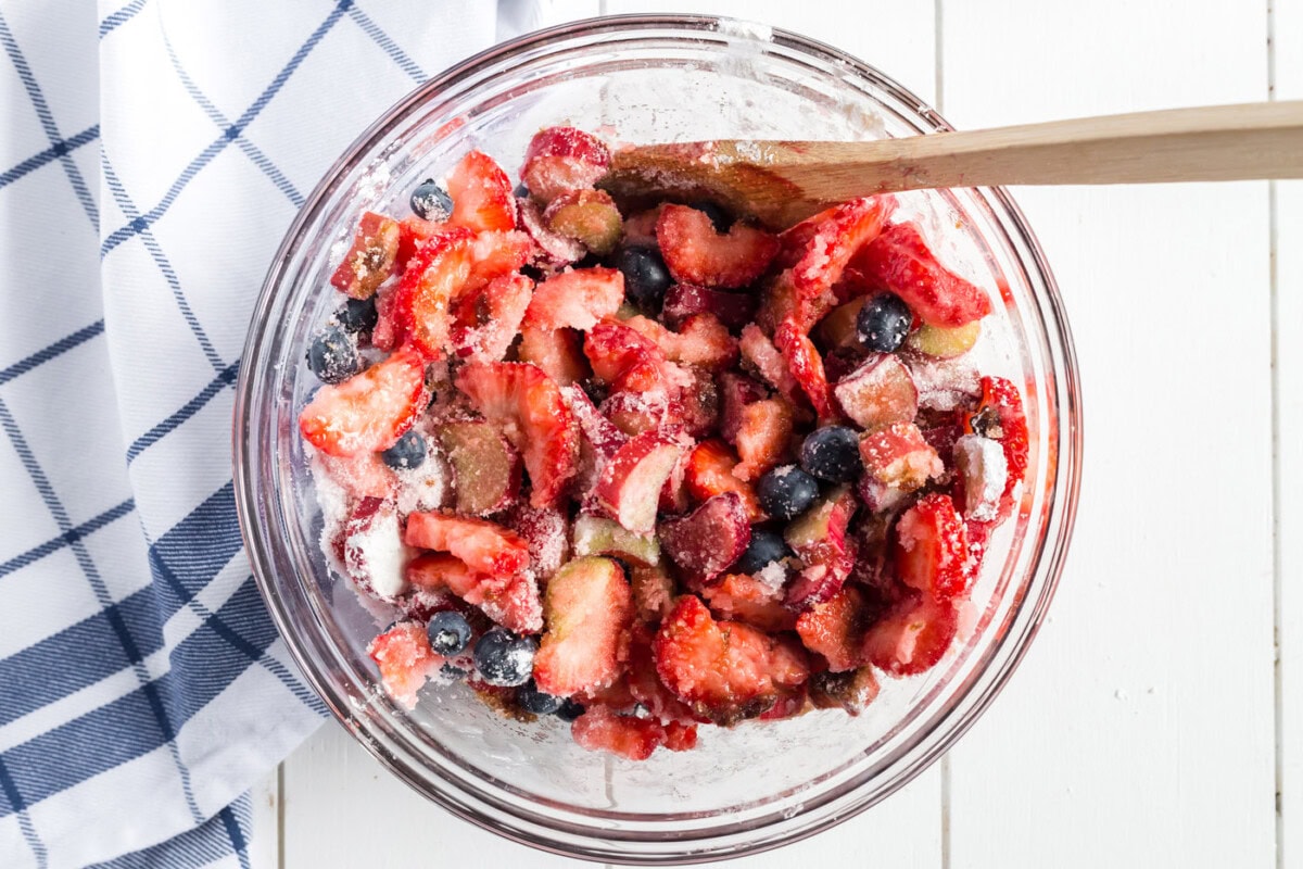 Bowl of rhubarb, strawberries, and blueberries, sugar, cornstarch and balsamic vinegar