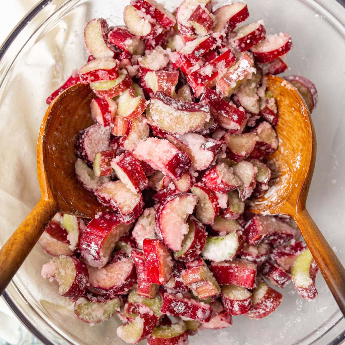 Bowl of rhubarb mixture with two wooden spoons in it