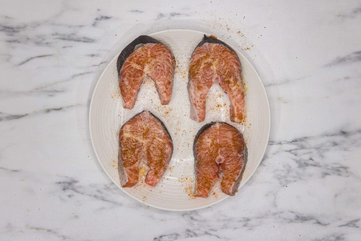 seasoned salmon steaks on a plate