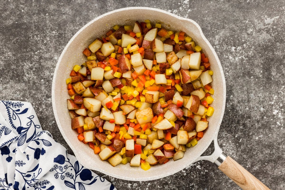 sausage with peppers and potatoes in a skillet