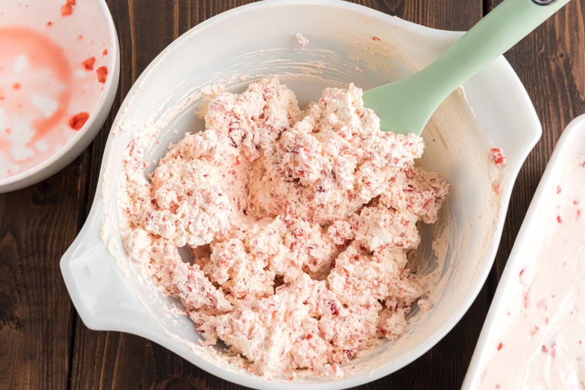 Strawberry and cool whip mixed in a bowl