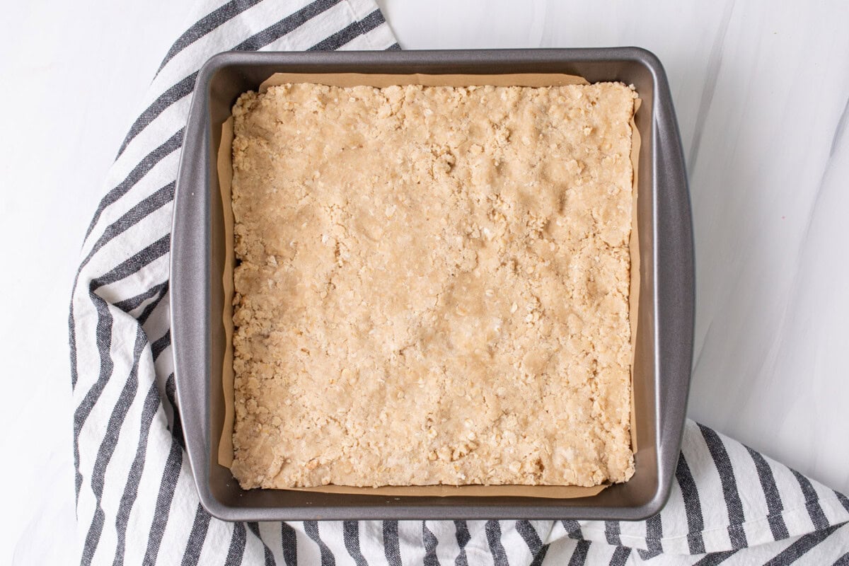 rhubarb crumble bars crust in a pan