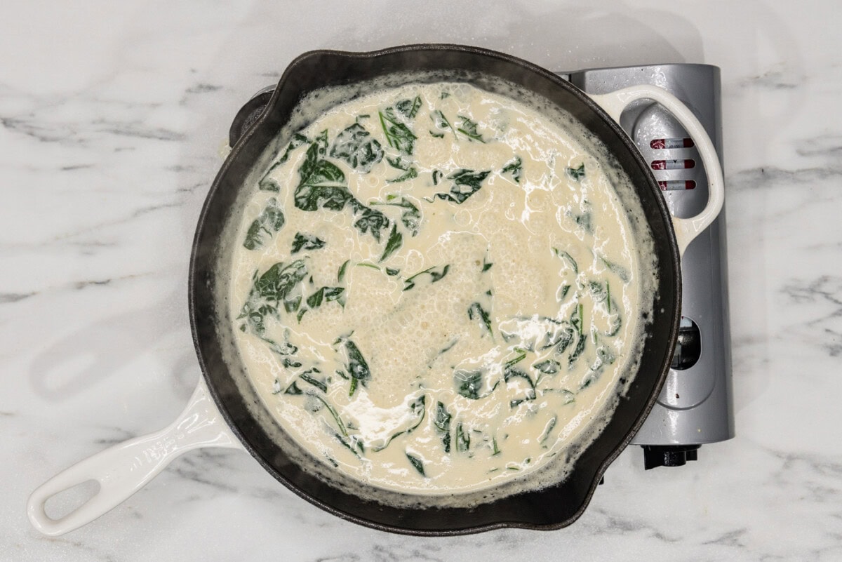 spinach in a skillet with cream sauce