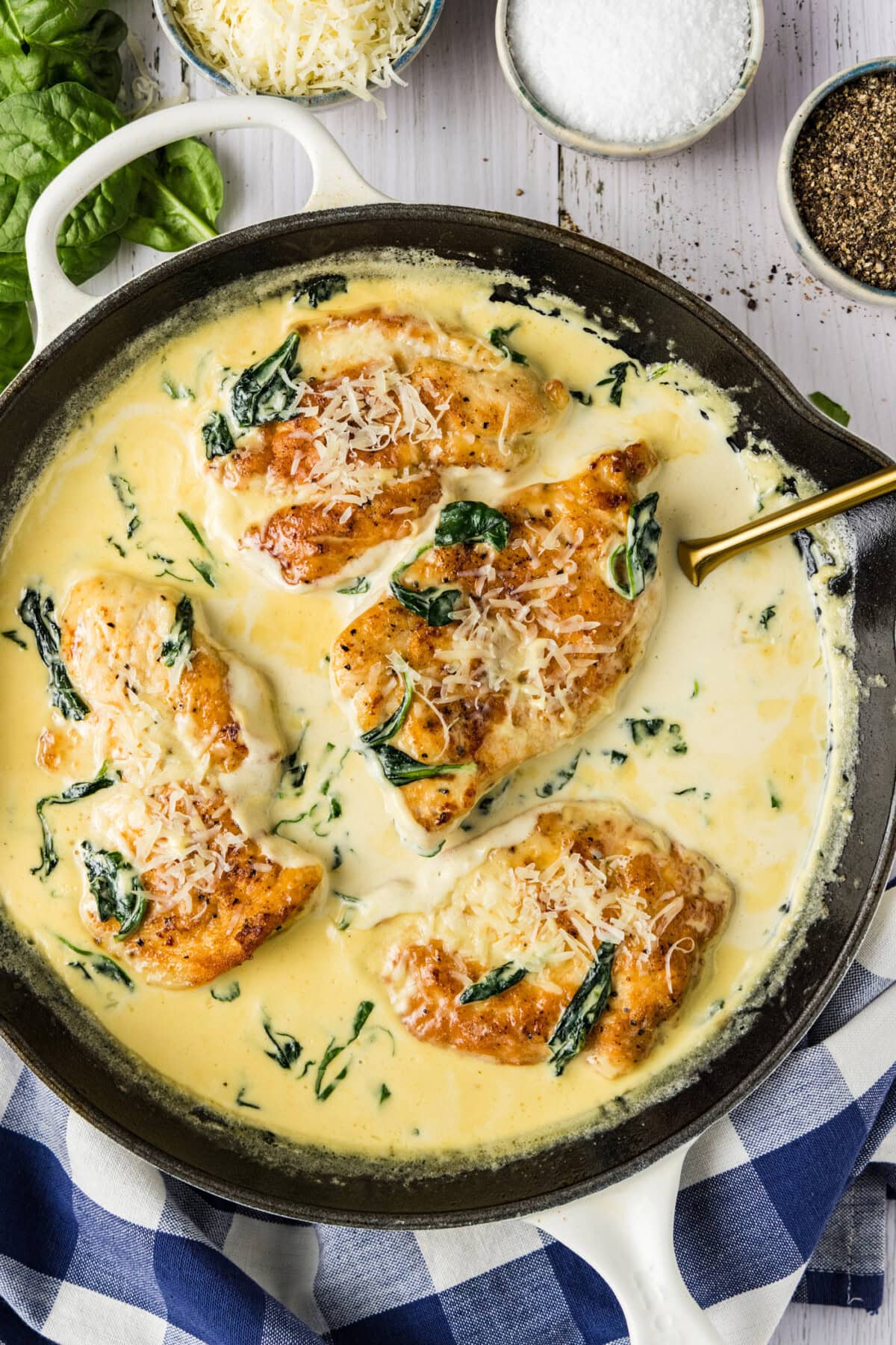 Skillet of Chicken Florentine with a spatula in it