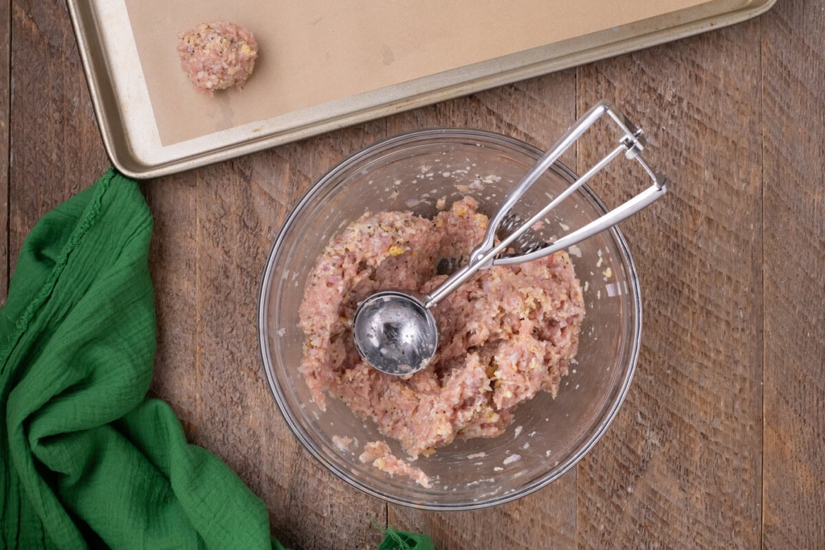 chicken meatball mixture in a bowl with a scoop