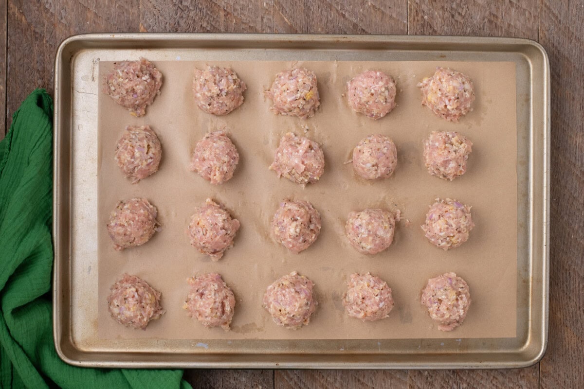 chicken meatballs on parchment lined baking shet