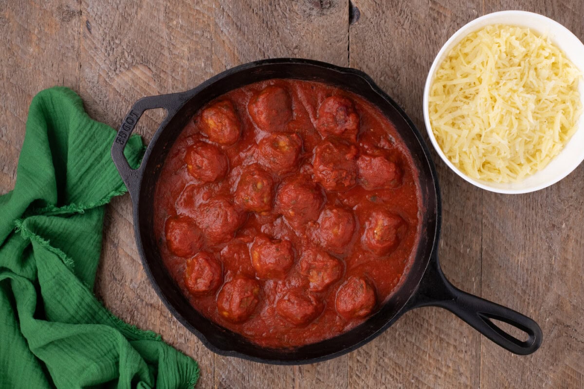 chicken meatballs in a skillet covered in marinara sauce