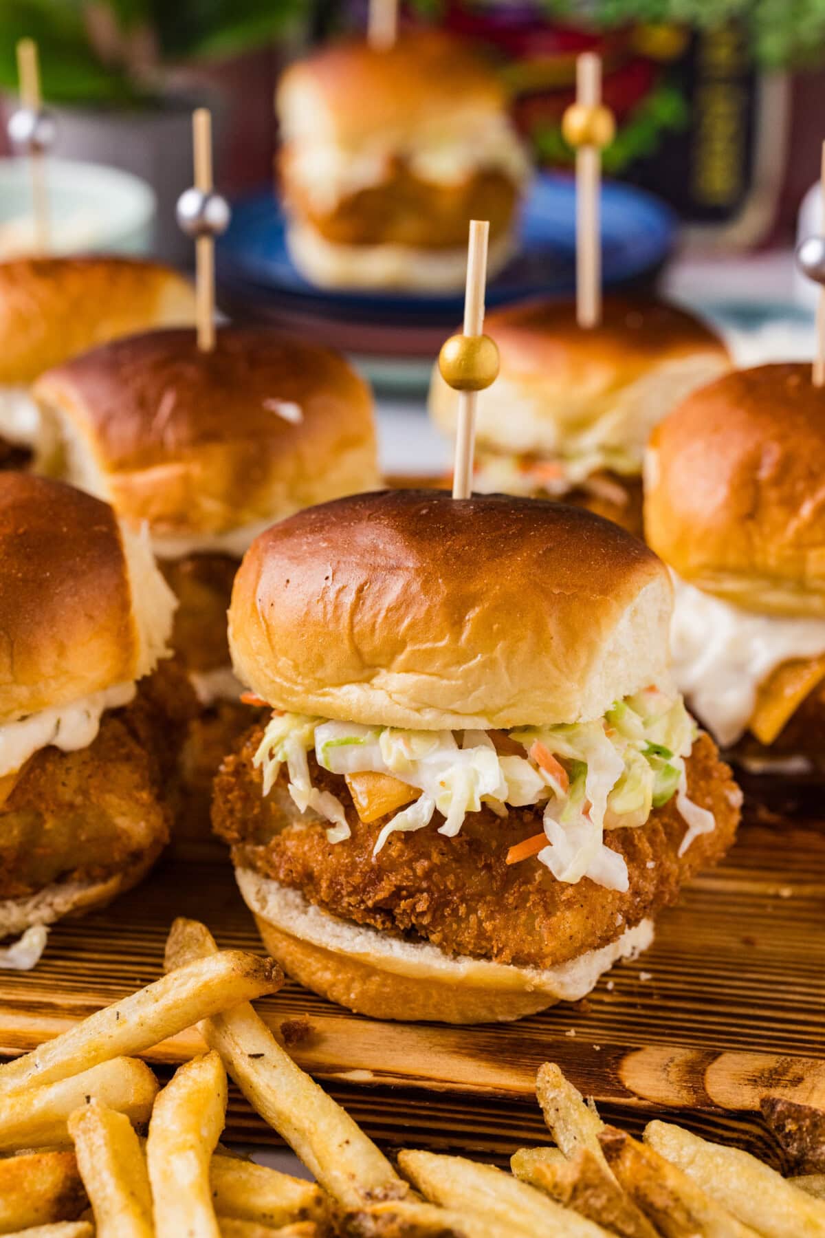Close up photo of a Fish Slider on a wooden platter with french fries