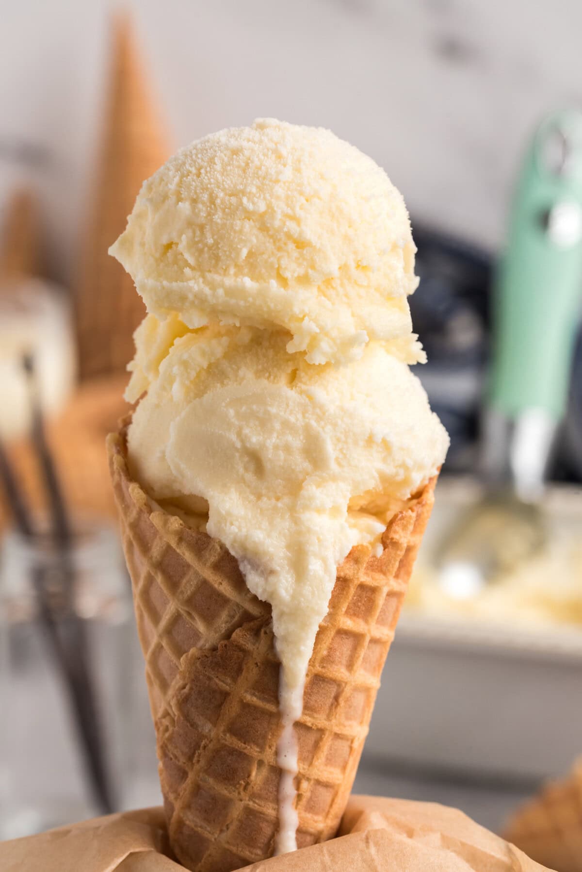 Two scoops of Homemade Vanilla Ice Cream in a waffle cone