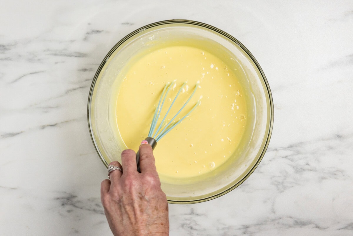 whisking key lime pie filling in a bowl