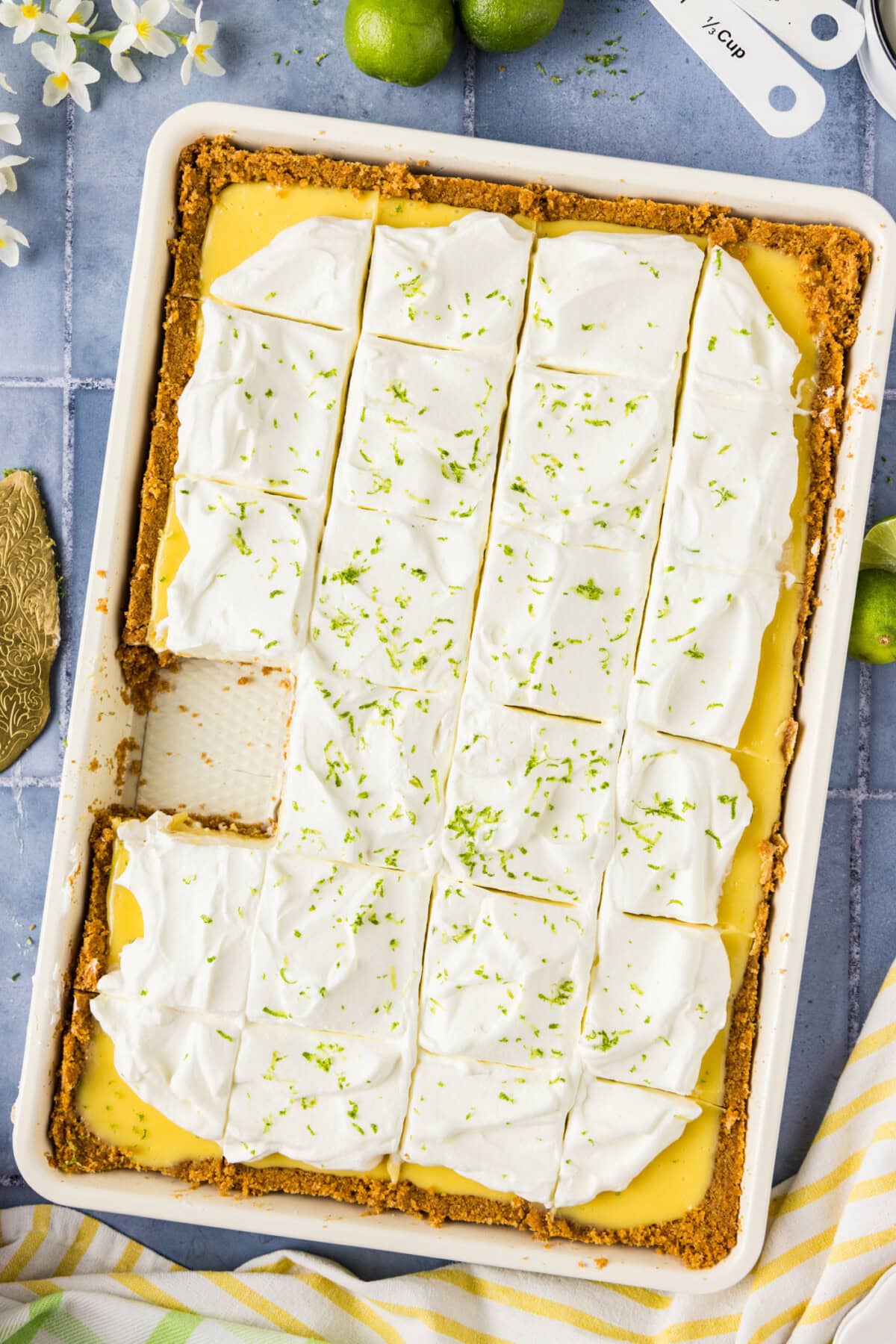 Key Lime Slab Pie cut into slices with a slice removed