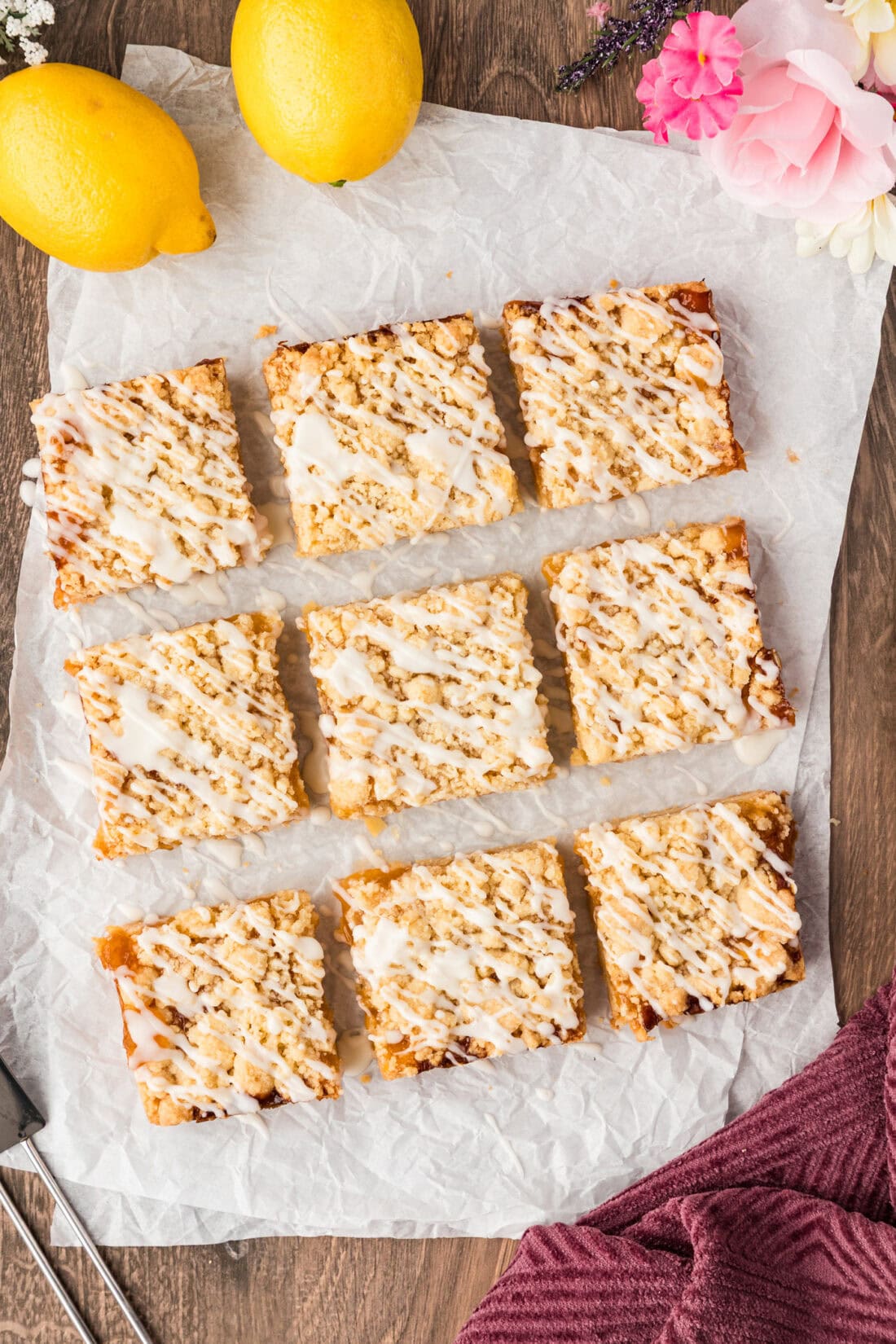 Lemon Streusel Squares cut into 9 squares resting on parchment paper