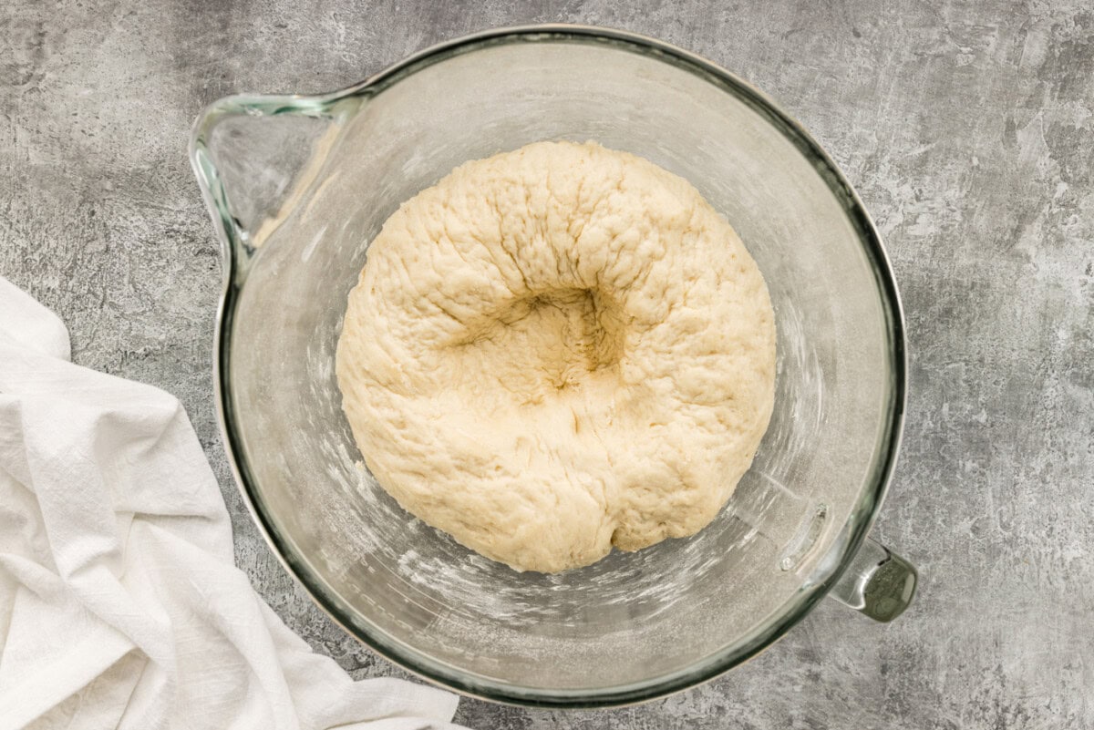 dough ball in a bowl with a punch mark