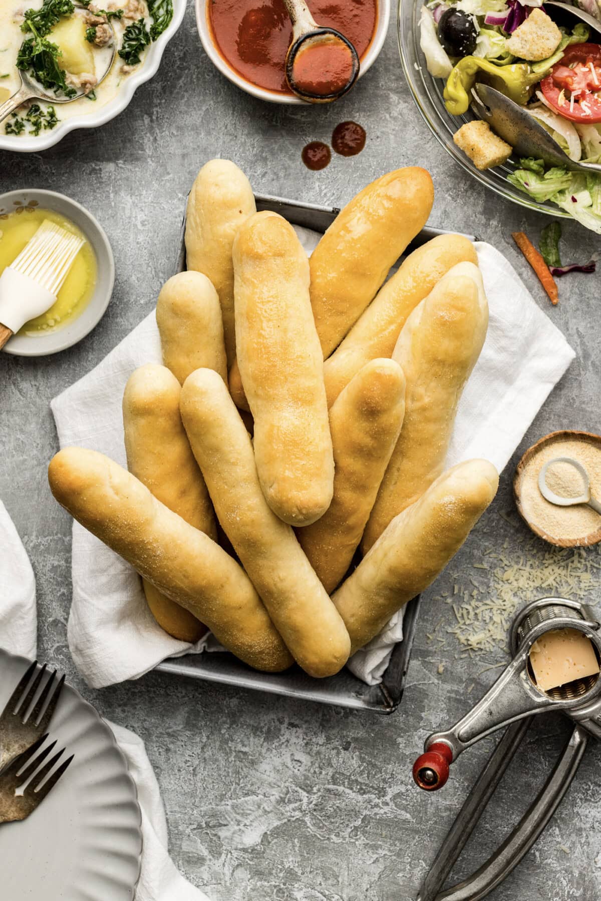 Basket of Olive Garden Breadsticks with soup and salad on the side