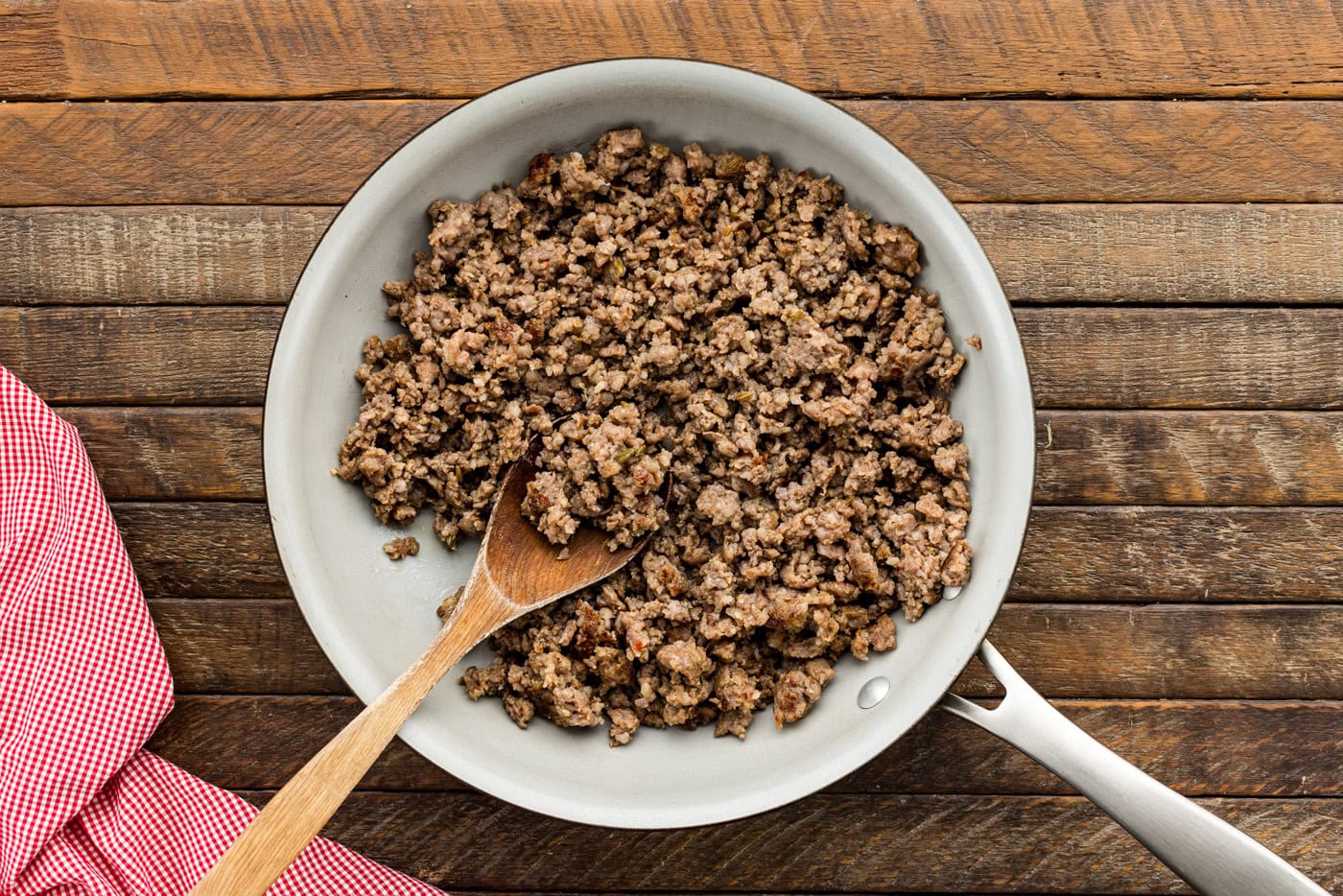cooked and crumbled italian sausage in a skillet
