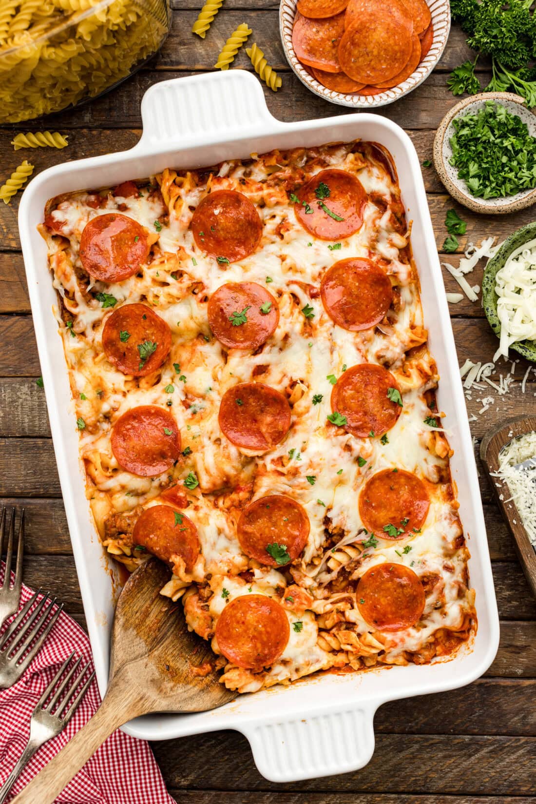 Serving spoon resting in a Sausage & Pepperoni Pizza Casserole