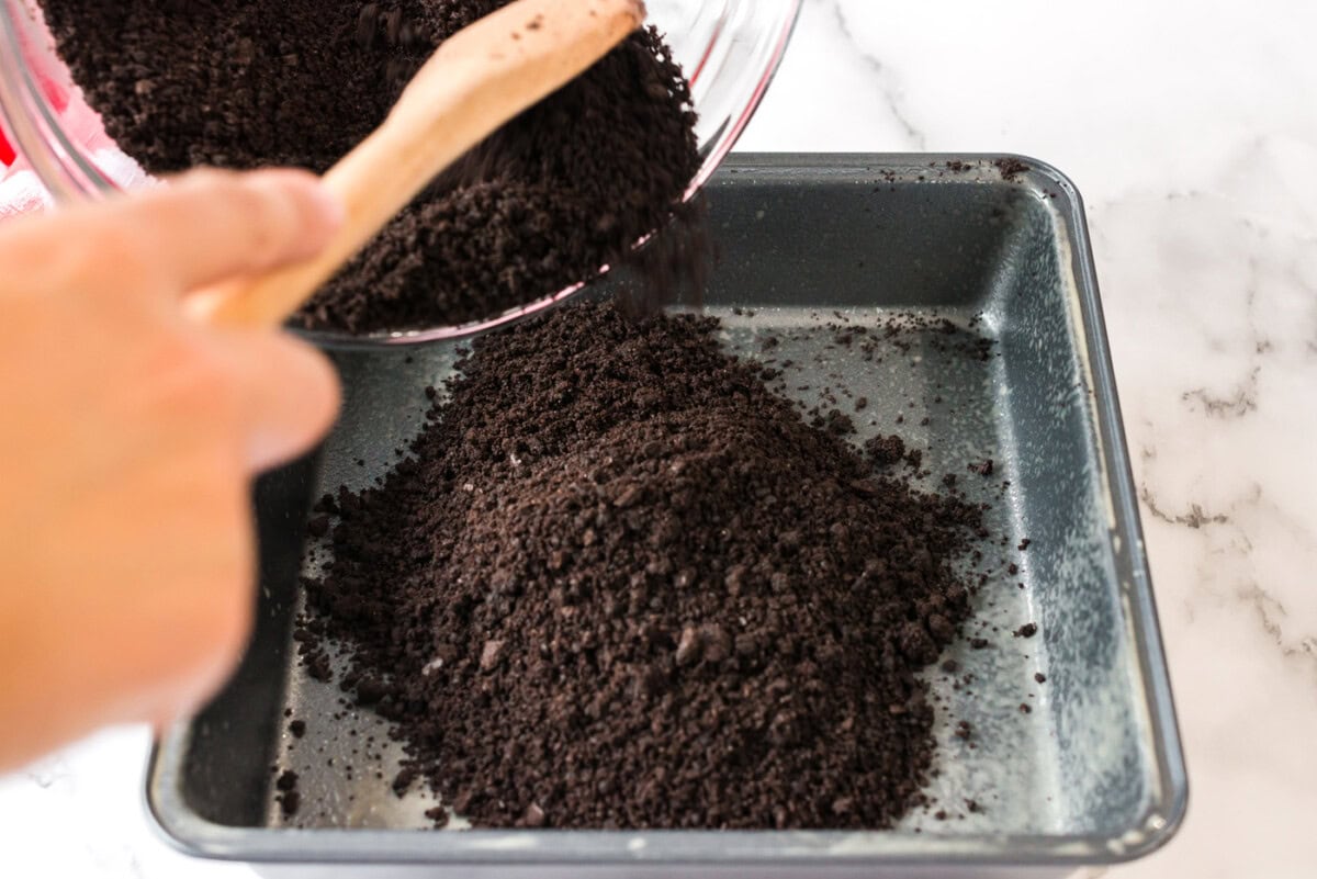 Crumb mixture being poured into a pan