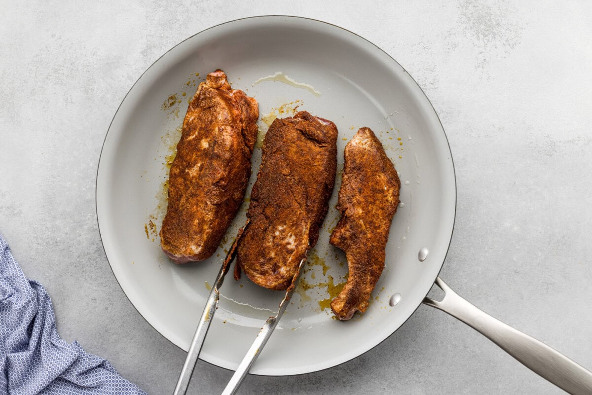 searing country style ribs in a skillet