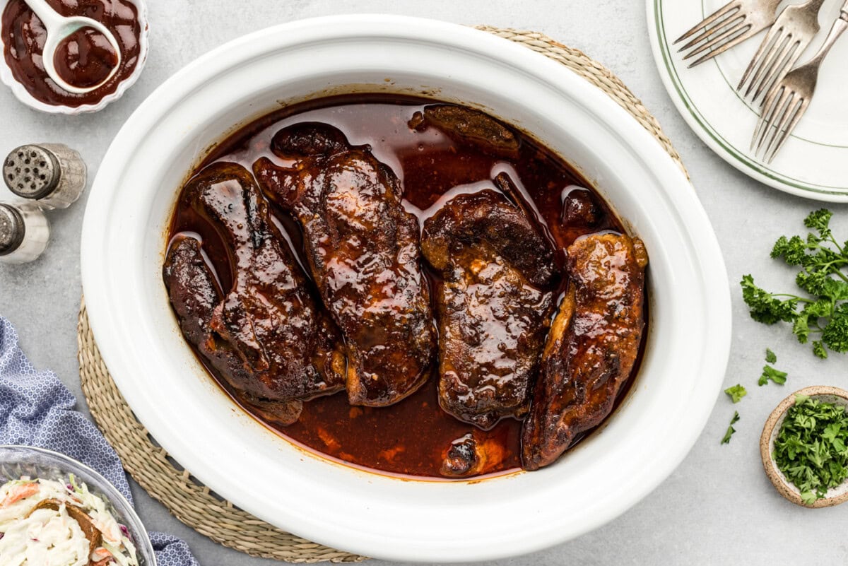 slow cooker country style ribs with barbecue sauce in a crock
