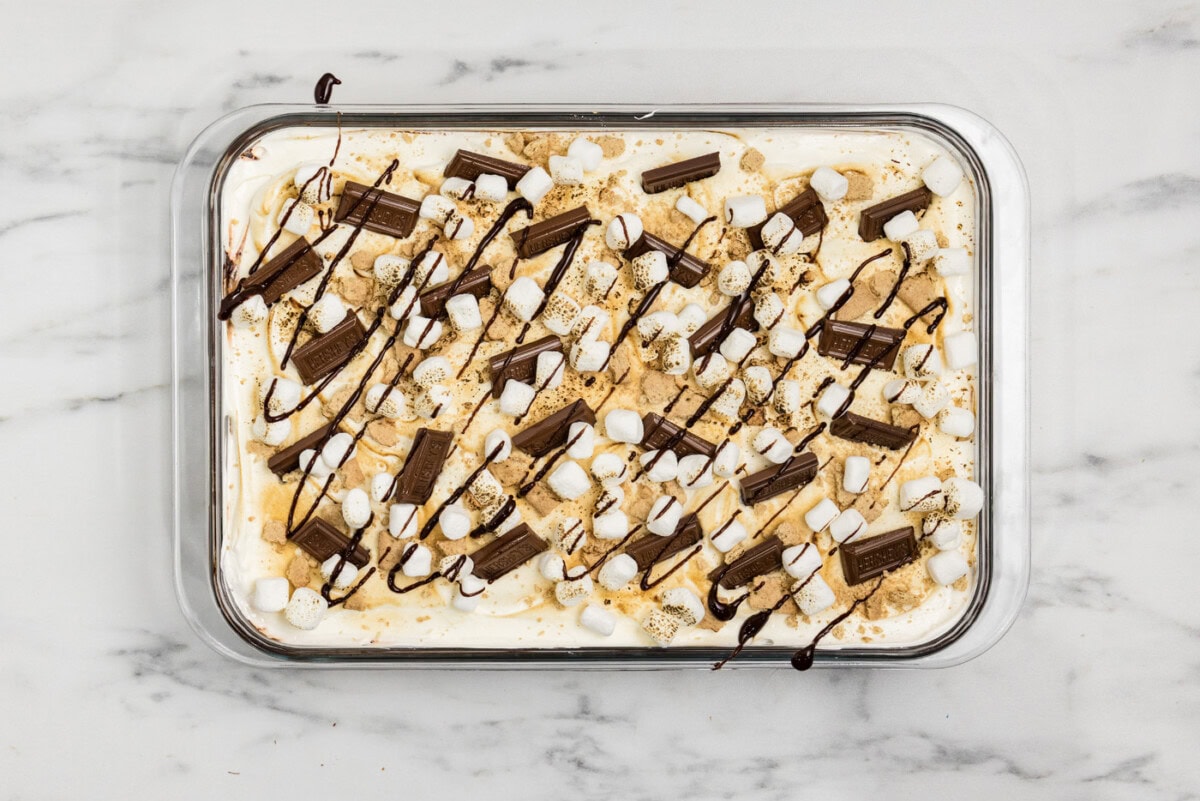 overhead shot of smores lasagna with chocolate bars and mini marshmallow garnish