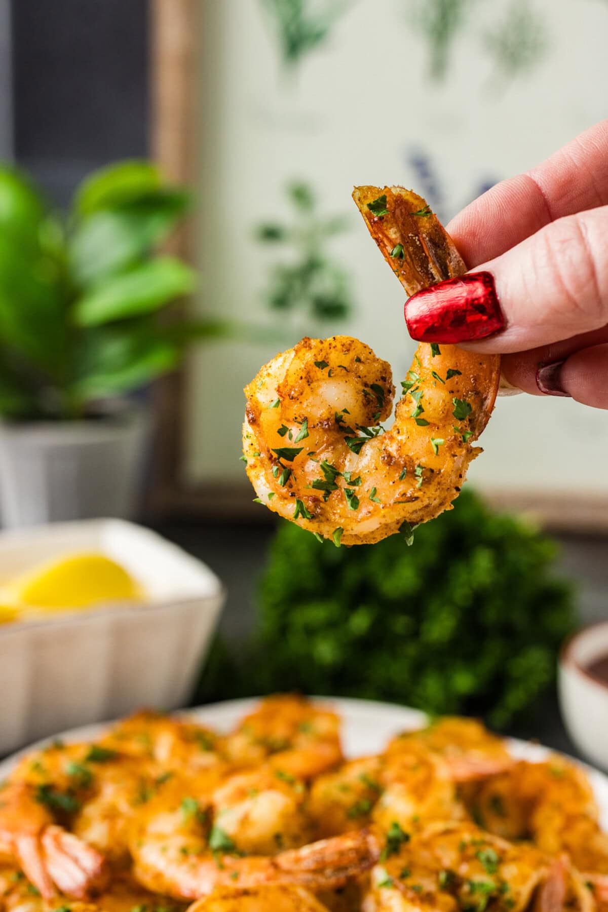 Hand holding up a Broiled Shrimp