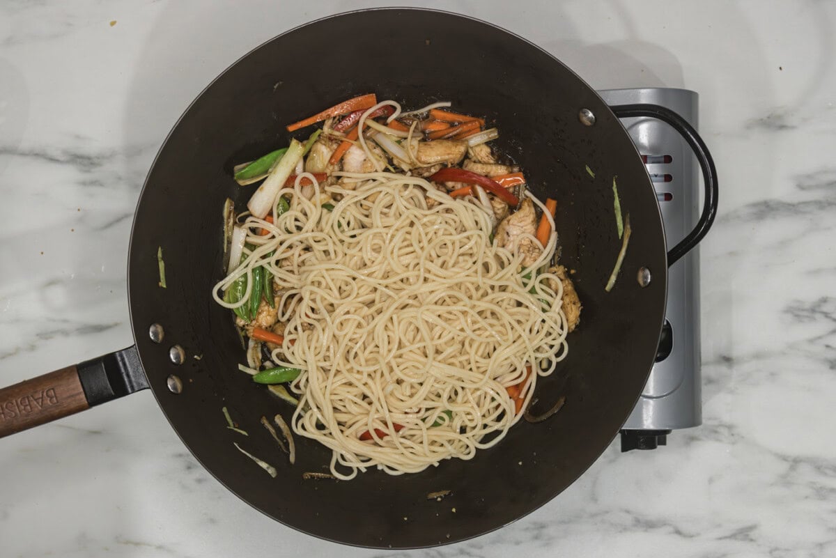 lo mein noodles added to skillet with vegetables and chicken