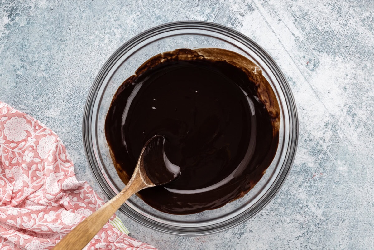melted chocolate in a bowl with a wooden spoon